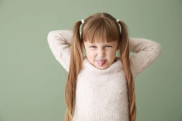 Portrait of angry little girl on color background — Stock Photo, Image