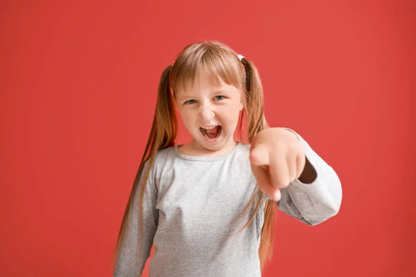 Portrait of angry little girl on color background — Stock Photo, Image