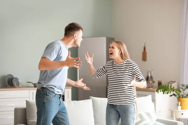 Angry couple having arguments at home