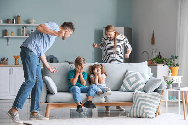 Angry parents scolding their little children at home