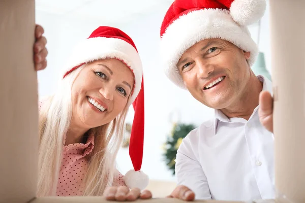 Happy mature couple opening Christmas present, bottom view — Stock Photo, Image