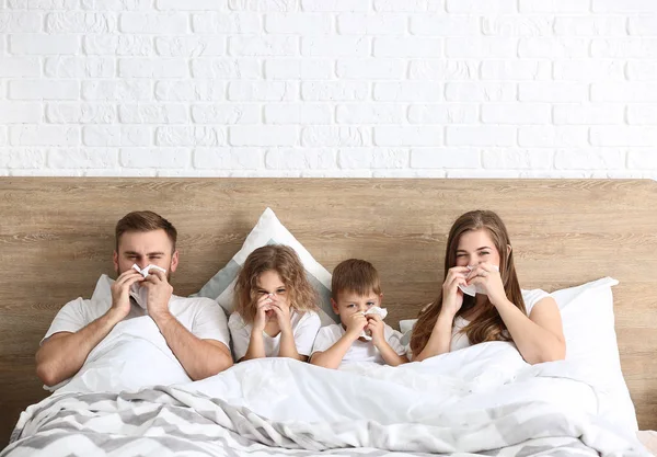 Family ill with flu in bed at home — Stock Photo, Image