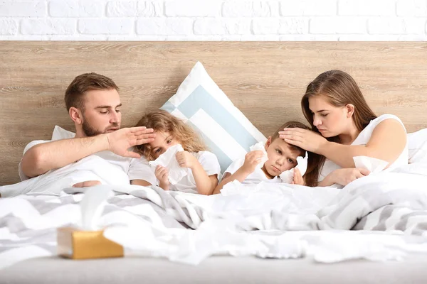 Family ill with flu in bed at home — Stock Photo, Image