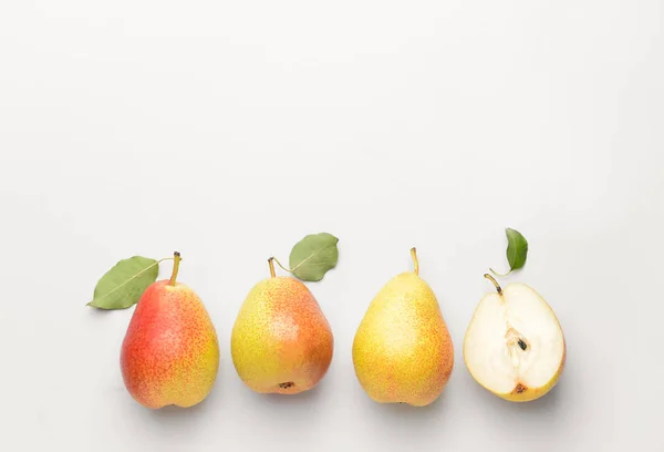 Whole pears and one half on white background. Concept of uniqueness — Stock Photo, Image
