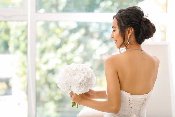 Beautiful young Asian bride near window — Stock Photo, Image