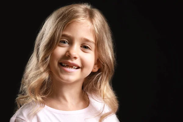 Cute little girl on dark background — Stock Photo, Image