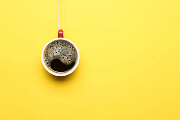 Creative Christmas composition with cup and string on color background