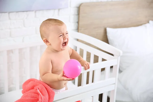 Crying little baby in crib — Stock Photo, Image