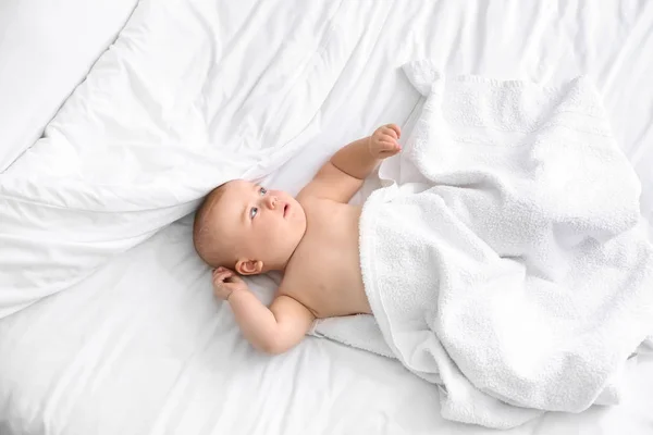 Cute little baby after bathing lying on bed — Stock Photo, Image