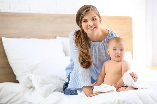 Woman and her cute little baby after bathing in bedroom — Stock Photo, Image