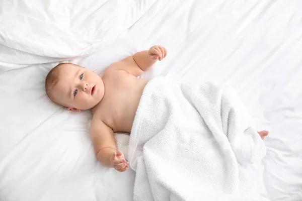 Cute little baby after bathing lying on bed — Stock Photo, Image