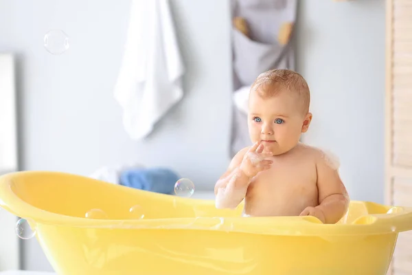 Cute little baby in bathtub at home — Stock Photo, Image