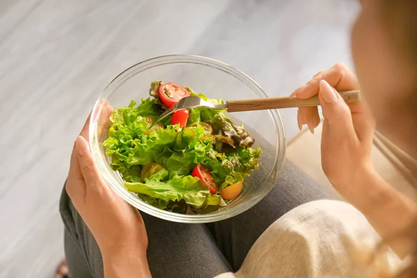 Mulher comendo saborosa salada de legumes em casa, close-up — Fotografia de Stock