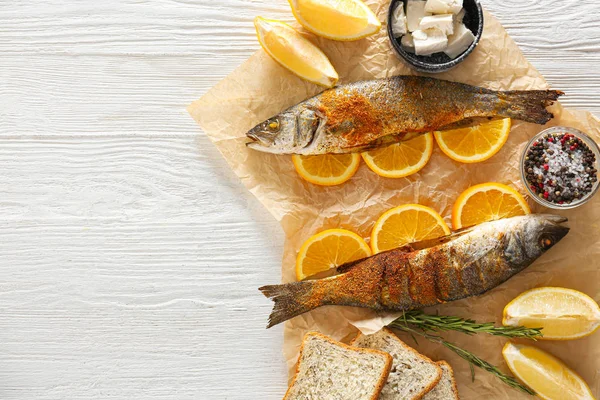 Tasty cooked seabass fish on white table — Stock Photo, Image