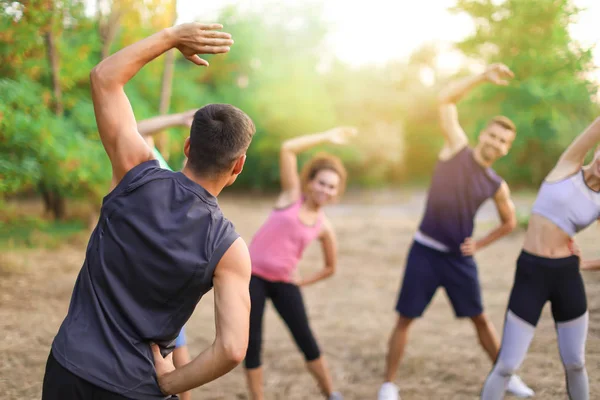 Sporty young people training outdoors — Stock Photo, Image
