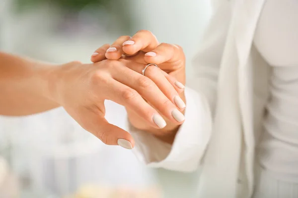 Young lesbian couple exchanging rings during wedding ceremony, closeup — Stock Photo, Image