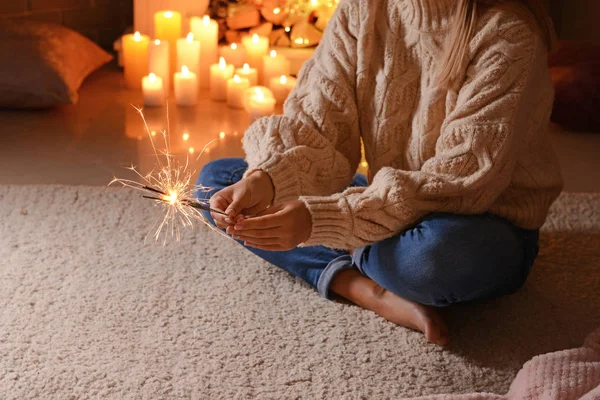 Young woman with Christmas sparklers sitting in room, closeup — Stock Photo, Image