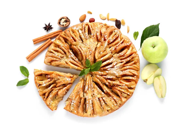 Sweet apple pie and ingredients on white background