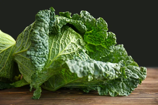 Fresh savoy cabbage on wooden table — Stock Photo, Image