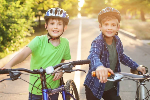 Cute children riding bicycles outdoors — Stock Photo, Image