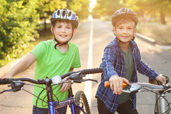 Cute children riding bicycles outdoors