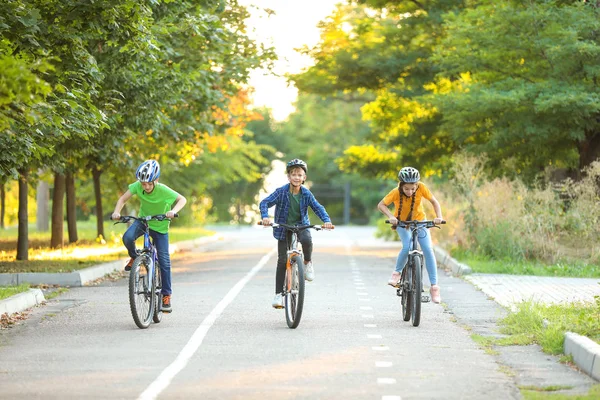 Cute children riding bicycles outdoors — Stock Photo, Image