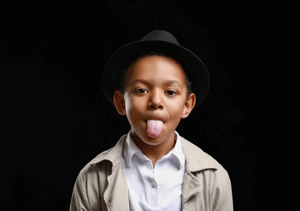 Grimacing African-American boy on dark background — Stock Photo, Image