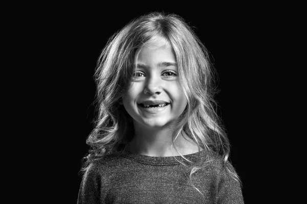Retrato preto e branco de menina feliz no fundo escuro — Fotografia de Stock