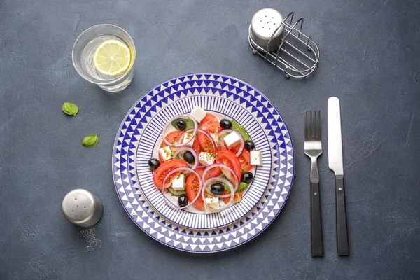 盘子与美味的希腊沙拉在黑暗的背景 — 图库照片