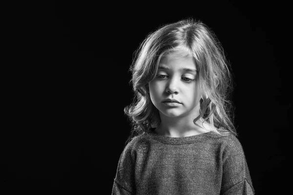Black and white portrait of sad little girl on dark background — Stock Photo, Image