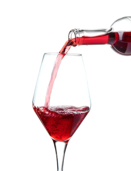 Pouring of wine into glass on white background Stock Picture