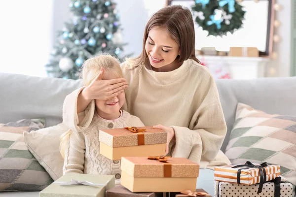 Young woman greeting her little daughter on Christmas eve — Stock Photo, Image