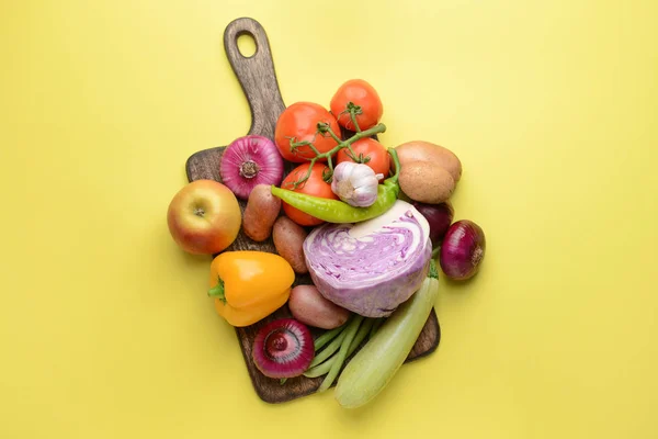 Board with many healthy vegetables on color background — Stock Photo, Image