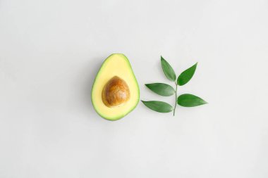 Beyaz arka planda taze olgun avokado yarısı