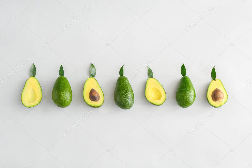 Fresh ripe avocados on white background