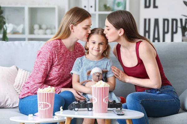 Happy lesbian couple with little daughter at home — Stock Photo, Image