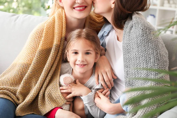 Happy lesbian couple with little daughter at home — Stock Photo, Image