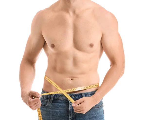 Handsome muscular man with measuring tape on white background. Weight loss concept — Stock Photo, Image