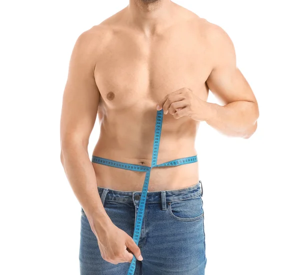 Handsome muscular man with measuring tape on white background. Weight loss concept — Stock Photo, Image