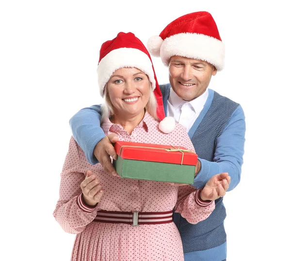 Happy mature couple with Christmas present on white background — Stock Photo, Image