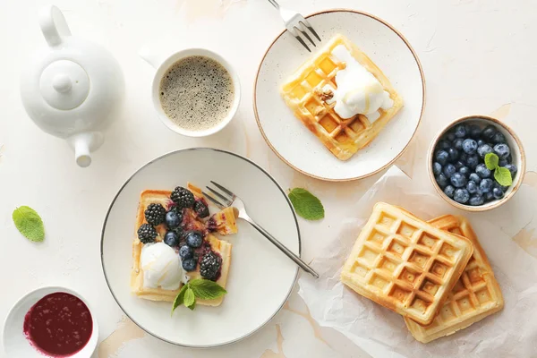 Tasty waffles with berries, ice-cream and coffee on white table — Stock Photo, Image