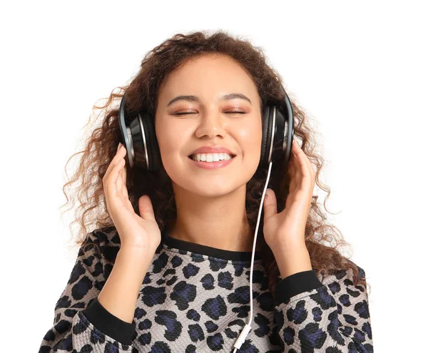 Beautiful African-American woman listening to music on white background — Stock Photo, Image
