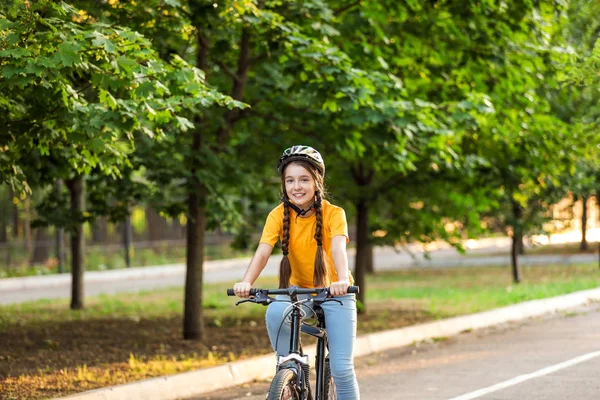 Cute girl riding bicycle outdoors — Stock Photo, Image