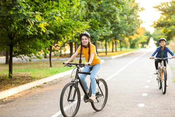 Cute children riding bicycles outdoors — Stock Photo, Image