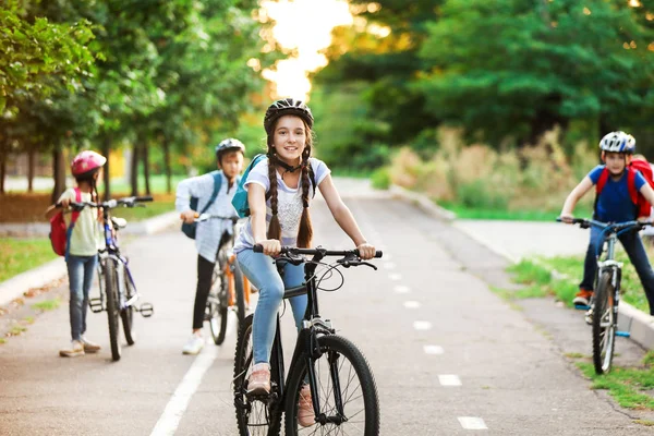 Cute children riding bicycles outdoors — Stock Photo, Image