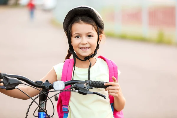 Cute girl riding bicycle outdoors — Stock Photo, Image