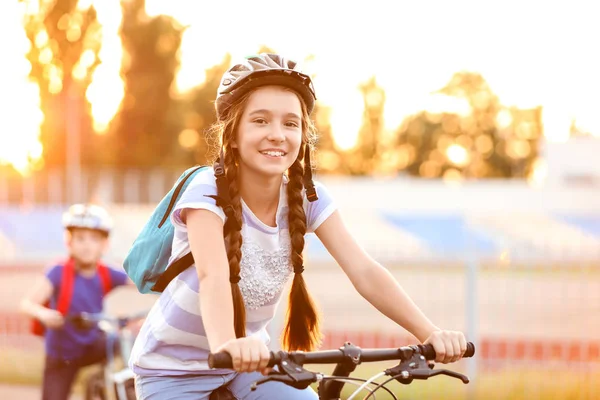 Cute girl riding bicycle outdoors — Stock Photo, Image