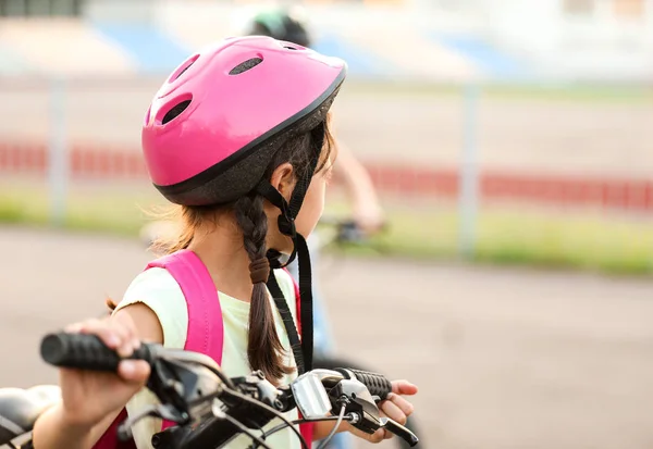 Cute girl riding bicycle outdoors — Stock Photo, Image