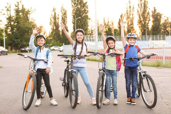 Cute children riding bicycles outdoors — Stock Photo, Image