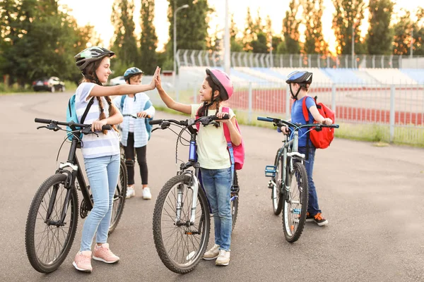Cute children riding bicycles outdoors — Stock Photo, Image